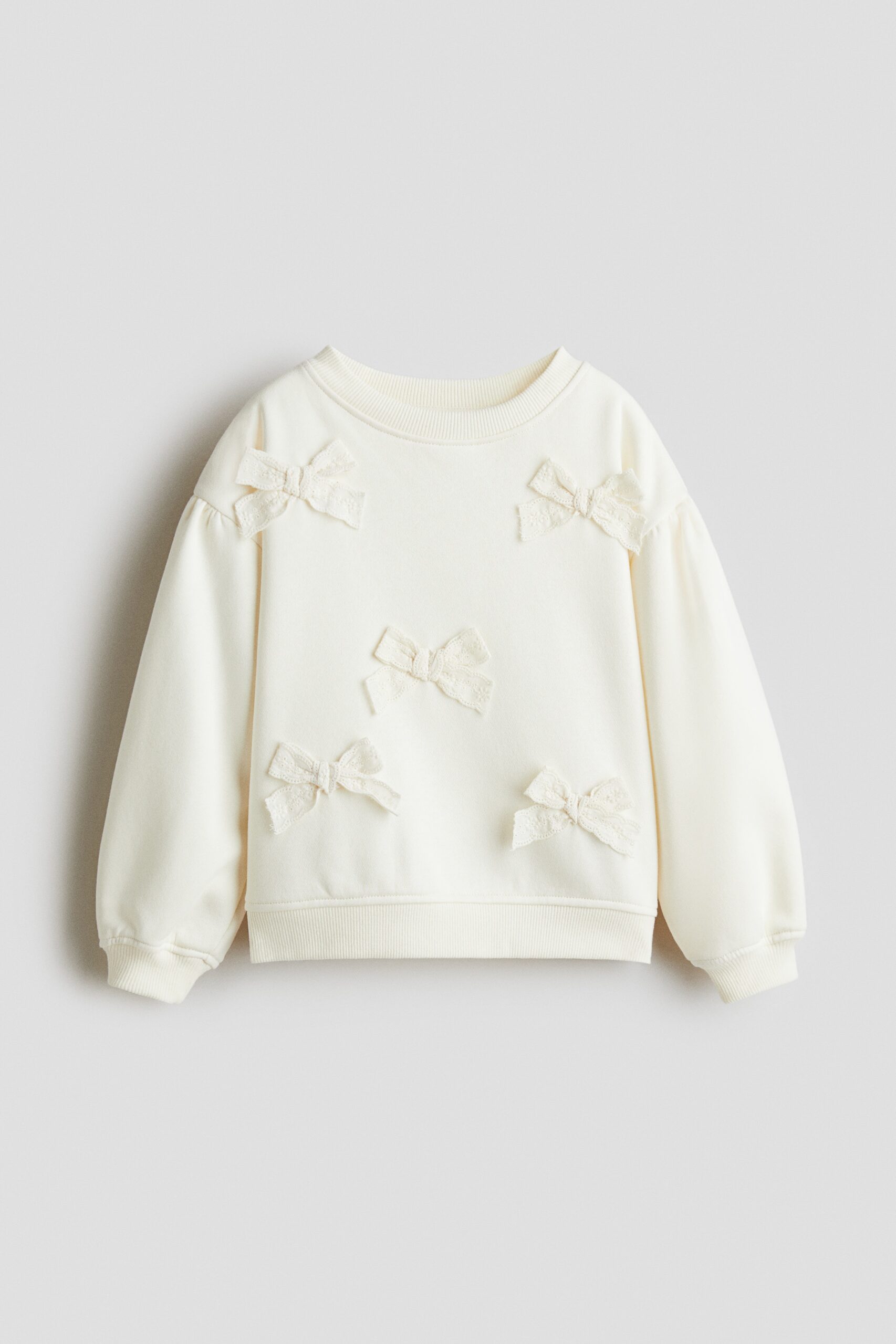 H & M - Sweater met applicaties en geruwde binnenkant - Roomwit/Strikjes