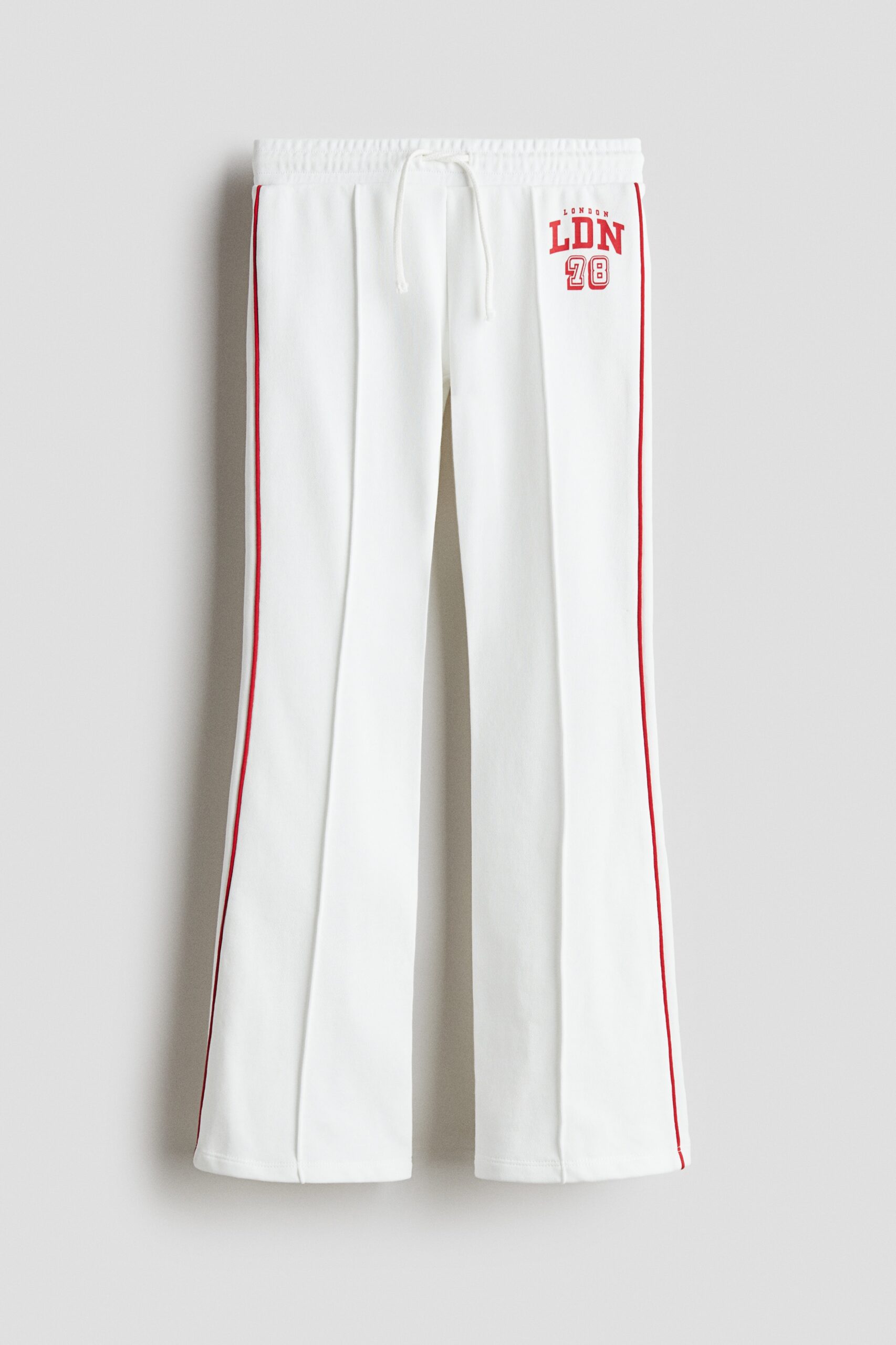 H & M - Flared joggers met persvouwen - Wit/London